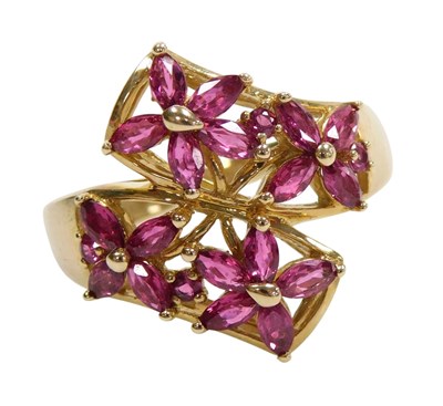 Lot 573 - A 9ct gold and ruby four flowerhead ring, in a...