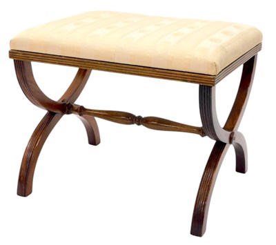 Lot 1202 - A mahogany stool in Regency style, on X shaped...