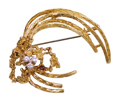 Lot 233 - An 18ct gold and diamond three stone brooch,...