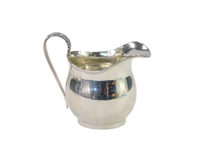 Lot 51 - A George VI silver cream jug, with a banded...