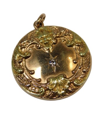 Lot 93 - A bi-colour locket, of circular form, set with...