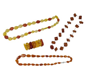 Lot 101 - A group of amber and resin jewellery,...