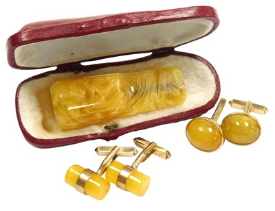 Lot 346 - A pair of yellow amber cufflinks, of...