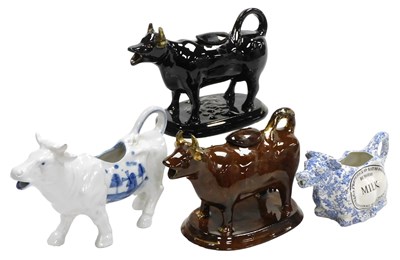 Lot 99 - A 19thC Jackfield black glazed cow creamer,...
