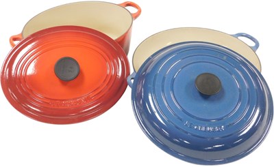 Lot 290 - A Le Creuset red enamel twin handled casserole...