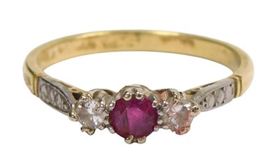 Lot 595 - A ruby and diamond three stone ring, in yellow...