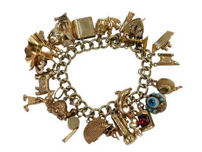 Lot 9 - A 9ct gold curb link charm bracelet, with...