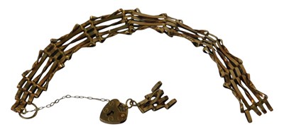 Lot 114 - A 9ct gold three-bar gate bracelet, with a...