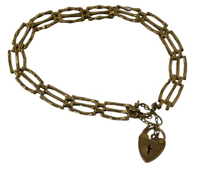 Lot 115 - A 9ct gold three-bar gate bracelet, with heart...
