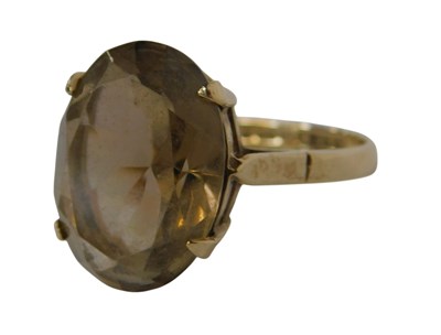 Lot 126 - A 9ct gold and smokey quartz ring, claw set,...