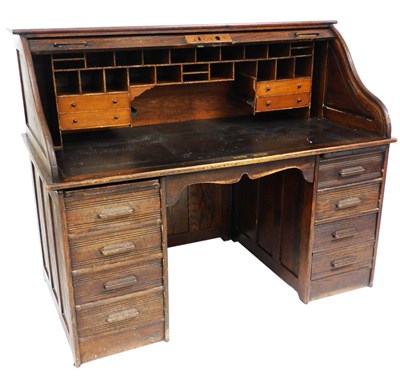 Lot 455 - An early 20thC oak roll top desk, with the...