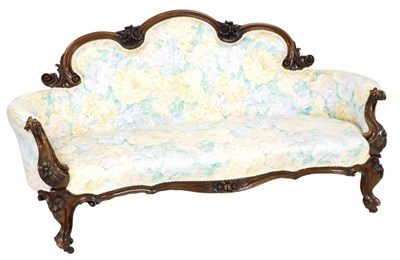 Lot 746 - A Victorian walnut show frame sofa, carved...