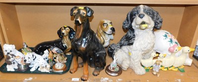 Lot 2032 - A group of dog figures, to include a dachshund,...