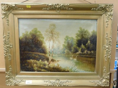Lot 2073 - 20thC school. Lake scene depicting swans, oil...