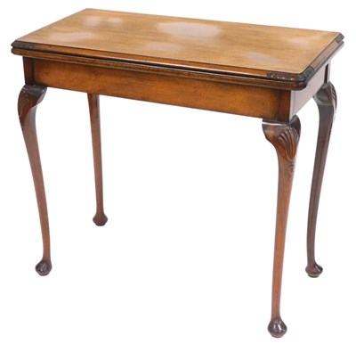 Lot 740 - A walnut card table, the rectangular hinged...