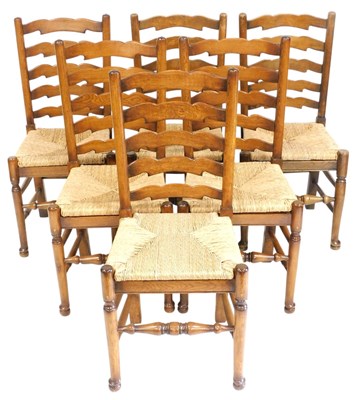 Lot 749 - A set of six oak ladder back dining...