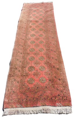 Lot 775 - A Bokhara red ground runner, the central field...