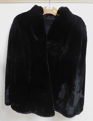 Lot 2197 - A black fur short jacket, underarm measurement...