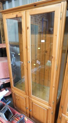 Lot 1137 - A pine display cabinet, with two glazed doors...