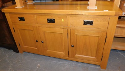 Lot 1001 - A contemporary light oak sideboard, with three...