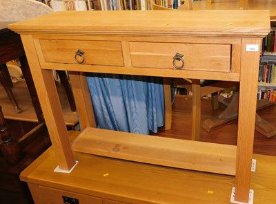 Lot 1002 - A contemporary light oak side table, the top...