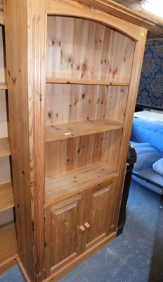 Lot 1066 - A pine open bookcase, the top with a moulded...