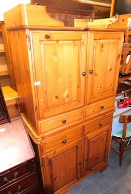Lot 1073 - A pair of pine side cabinets, each with two...