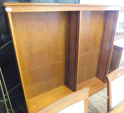 Lot 1101 - A twin division open bookcase, the top with a...