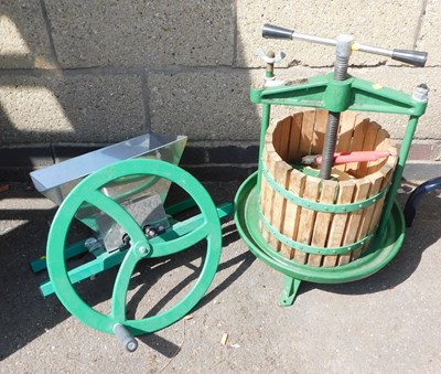 Lot 1119 - A Vigo fruit press, together with an apple...