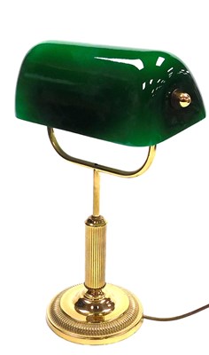 Lot 643 - A brass angular table lamp, with a green and...