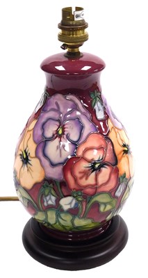 Lot 670 - A Moorcroft pottery Pansy pattern table lamp,...