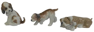 Lot 216 - Three Lladro porcelain figures of dogs, in...