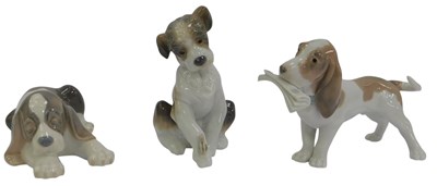 Lot 218 - Three Lladro porcelain figures of dogs, in...