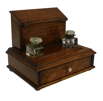Lot 241 - An early 20thC oak desk stand, the top with a...