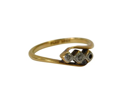 Lot 338 - A diamond three stone ring, in a cross over...