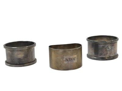 Lot 34 - Three silver napkin rings, comprising a George...