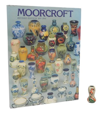 Lot 357 - A Moorcroft pottery miniature vase, decorated...