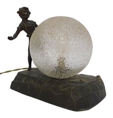 Lot 397 - An early 20thC cast metal table lamp, modelled...