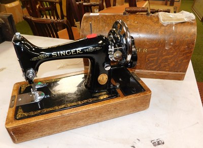 Lot 2248 - A Singer model 99 sewing machine, oak cased,...
