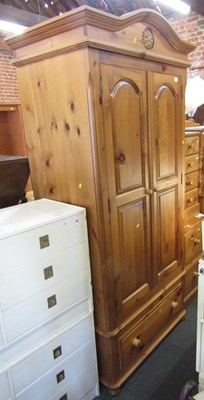 Lot 1004 - A pine two door wardrobe, cornice above two...