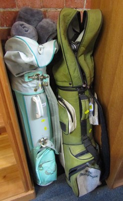 Lot 1033 - Two bags containing golf clubs, one containing...
