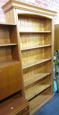 Lot 1034 - A pine open bookcase, with five shelves to...