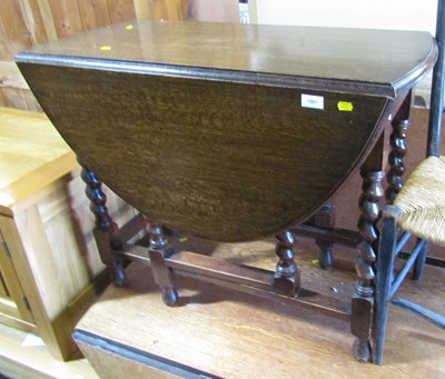 Lot 1067 - A small oak drop leaf dining table, with...