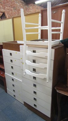 Lot 1072 - A pair of four drawer chests, finished in...
