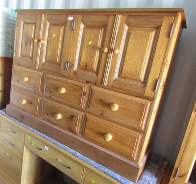 Lot 1095 - A large pine chest, with four cupboard doors...