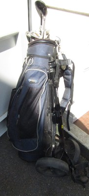 Lot 1105 - A set of golf clubs, in bag, with trolley by...