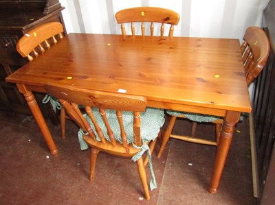 Lot 1108 - A light coloured wood kitchen table, raised on...