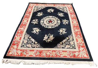 Lot 889 - A Chinese black ground rug, floral decorated,...