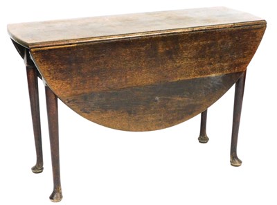 Lot 743 - A George III oak drop leaf dining...