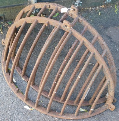 Lot 1127 - Two wall-mounted cast iron hay racks, 100cm wide.